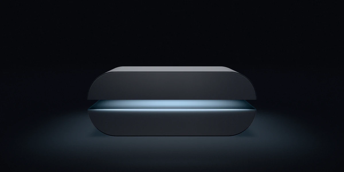 The Capsa case opening: its upper half lifts and cold light spills from the seam.
